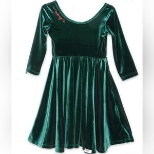 Green velvet holiday dress with embroidered “Merry” in red.